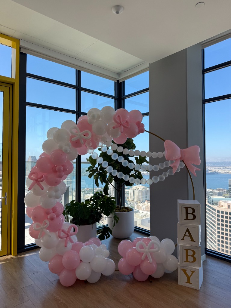 High-rise baby shower with pink and white hoop balloon decor downtown San Diego