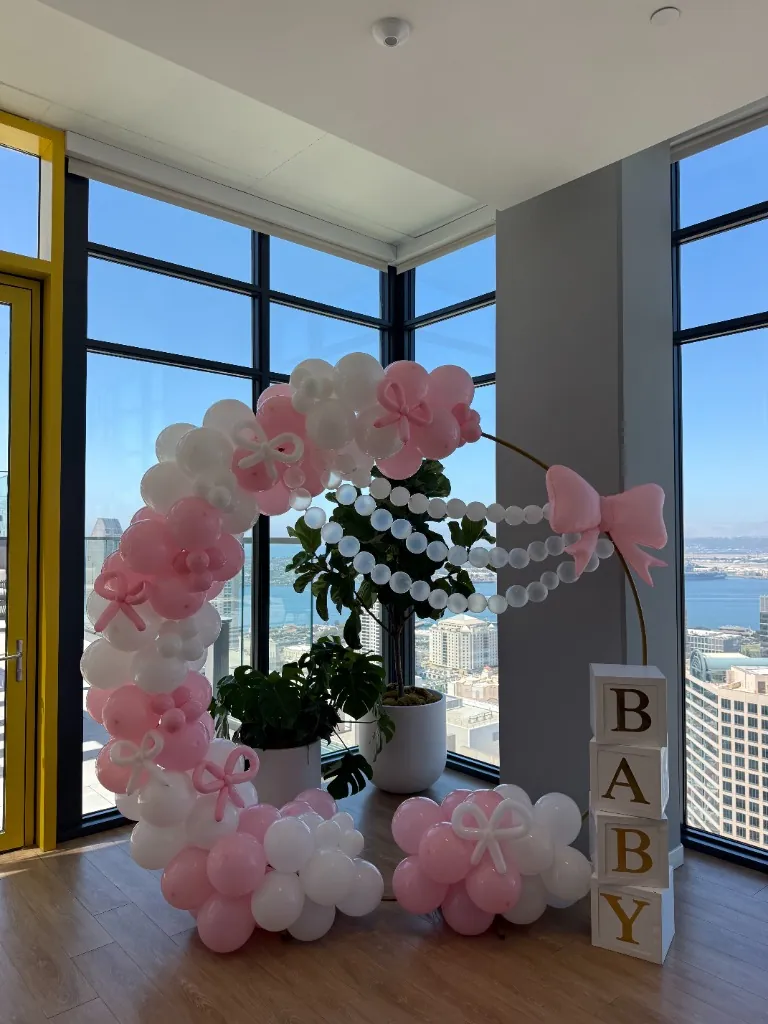 High-rise baby shower with pink and white hoop balloon decor downtown San Diego