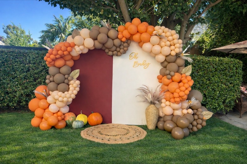 Autumn-themed 'Oh Baby' shower with pumpkin accents and organic balloon arch