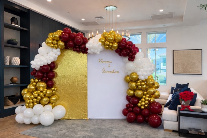 Luxury gold and burgundy indoor balloon installation for Neema & Jonathan